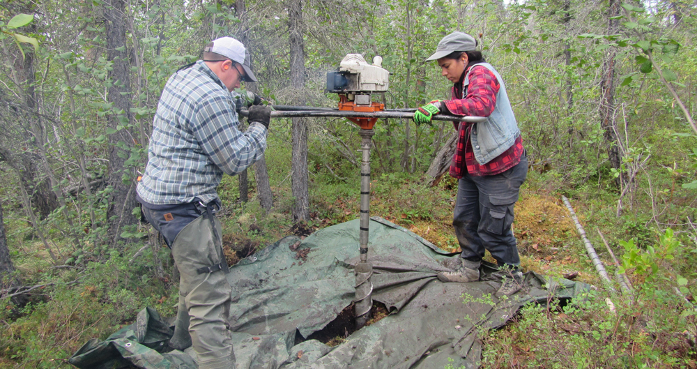 Jacqueline Goordial and a graduate student drilling through the thawed portion of the soil, into the permafrost. They use this technique to recover ~3 metres of core material. 