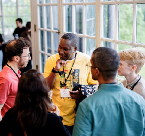 A photo of five scholars talking together.