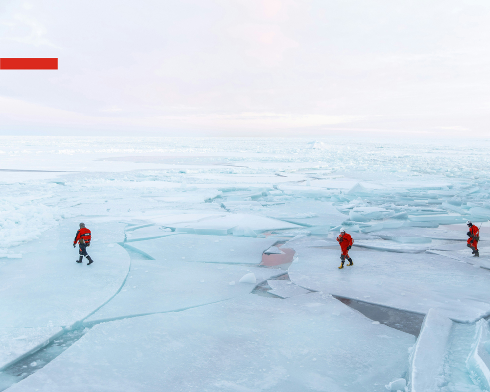 Rescue people walking on melted ice at the Arctic.